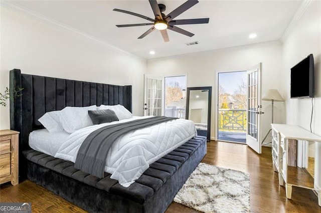bedroom featuring dark wood-style floors, visible vents, ornamental molding, and access to exterior