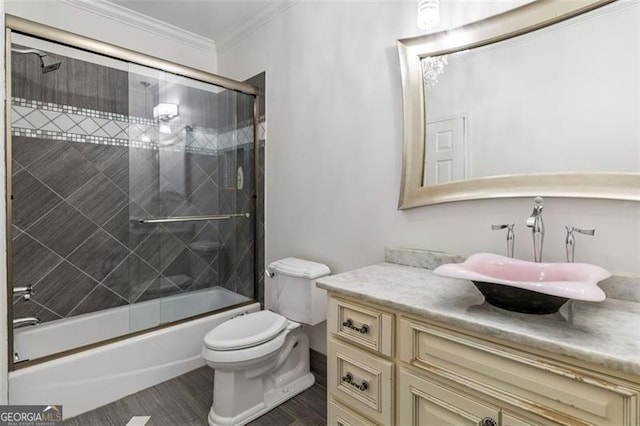 full bathroom featuring shower / bath combination with glass door, vanity, toilet, wood finished floors, and ornamental molding