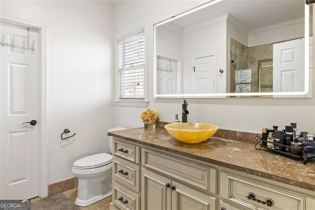 bathroom with vanity, tile patterned floors, toilet, ornamental molding, and tiled shower