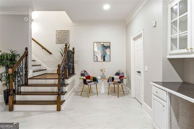 interior space featuring baseboards, ornamental molding, and marble finish floor