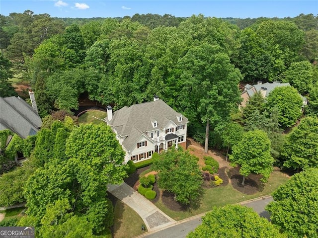 drone / aerial view featuring a view of trees