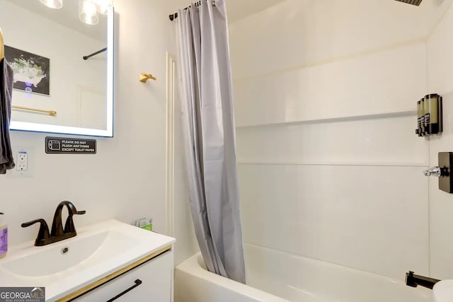 bathroom with shower / tub combo and vanity