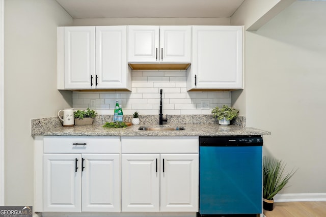 kitchen featuring a sink, white cabinetry, dishwasher, and tasteful backsplash