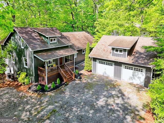 234 Raindance Ln, Clayton, GA 30525 - view of front facade featuring a porch, board and batten siding, driveway, a shingled roof, and a wooded view