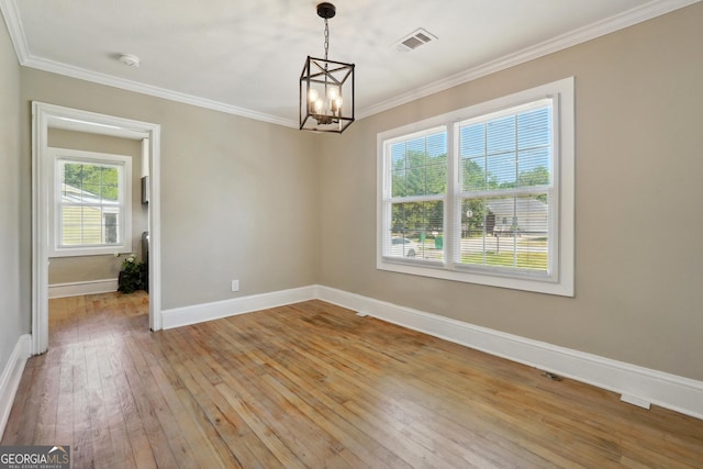 785 Alice St, Forest Park, GA 30297 - spare room featuring an inviting chandelier, baseboards, visible vents, ornamental molding, and hardwood / wood-style flooring