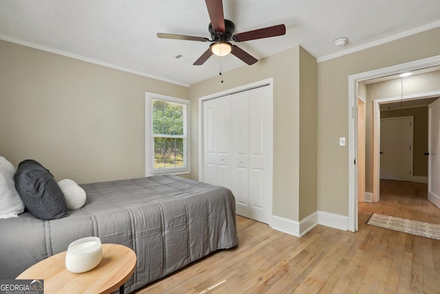 785 Alice St, Forest Park, GA 30297 - bedroom featuring a closet, ornamental molding, light wood-style floors, baseboards, and ceiling fan