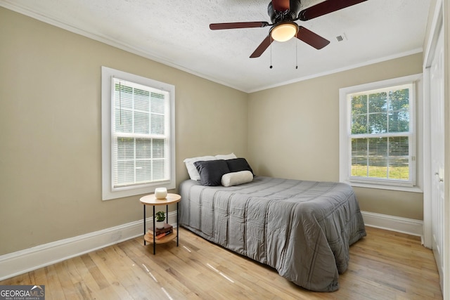785 Alice St, Forest Park, GA 30297 - bedroom with crown molding, light wood-style flooring, baseboards, and multiple windows