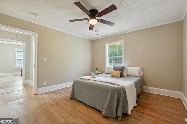 785 Alice St, Forest Park, GA 30297 - bedroom with visible vents, ornamental molding, baseboards, a textured ceiling, and light wood finished floors