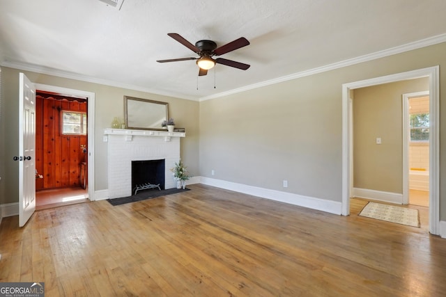 785 Alice St, Forest Park, GA 30297 - unfurnished living room featuring a healthy amount of sunlight, ceiling fan, a fireplace, and light wood-type flooring