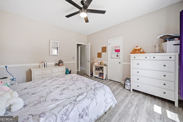 bedroom with ceiling fan and light wood-style floors