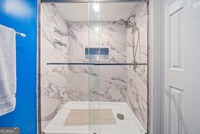 full bathroom featuring a marble finish shower