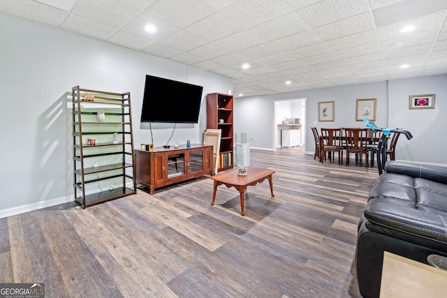 living area featuring baseboards and wood finished floors