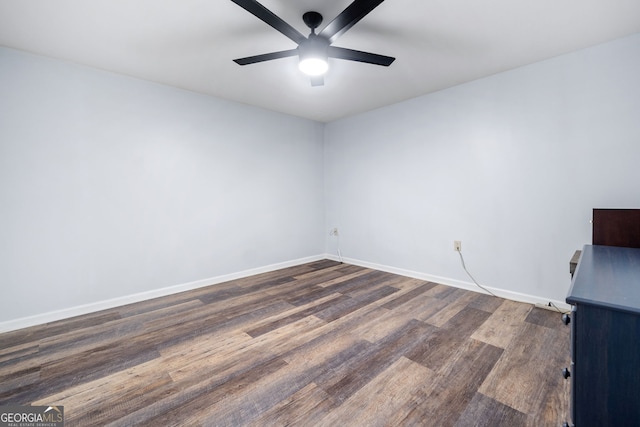 unfurnished room featuring a ceiling fan, baseboards, and wood finished floors