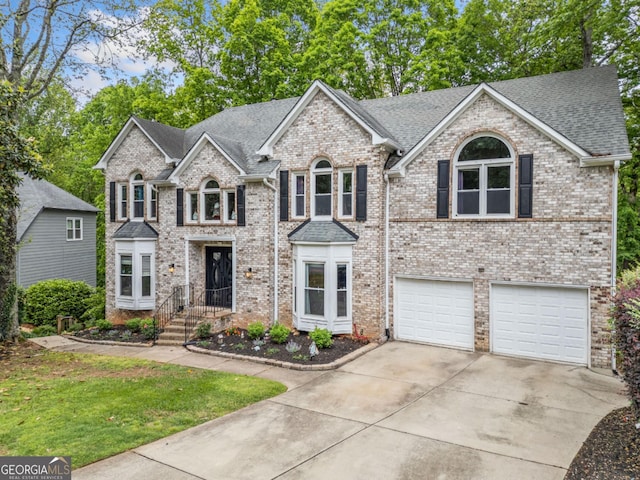 view of front of house featuring a front yard, a garage, brick siding, concrete driveway, and a shingled roof