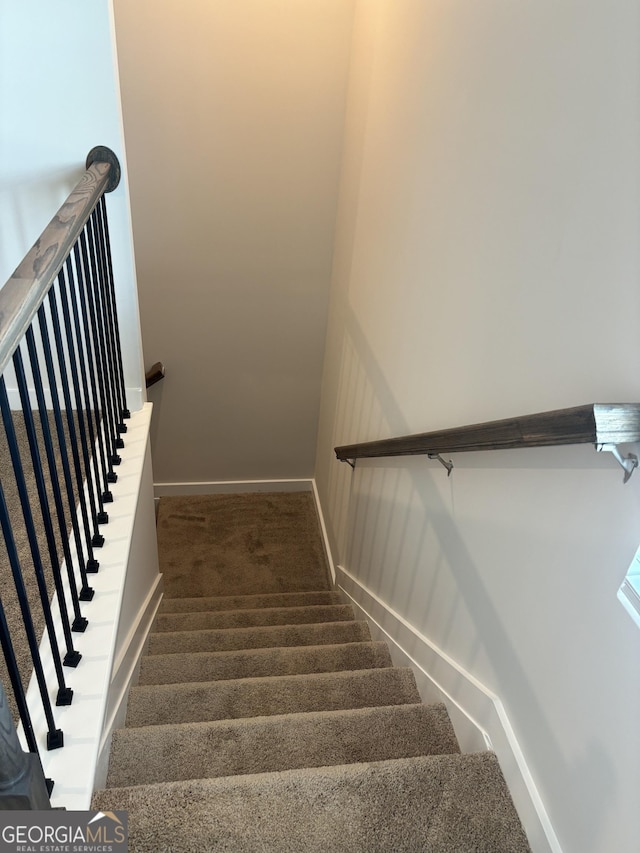stairway with carpet flooring and baseboards