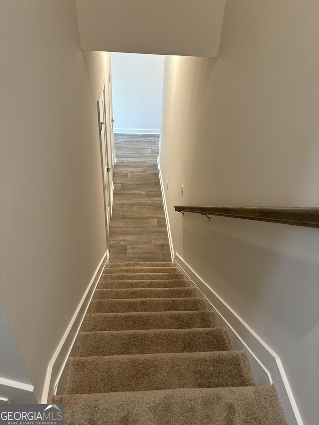 stairway featuring baseboards