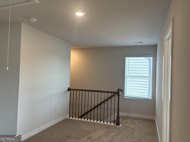 stairway featuring visible vents, carpet flooring, baseboards, and attic access
