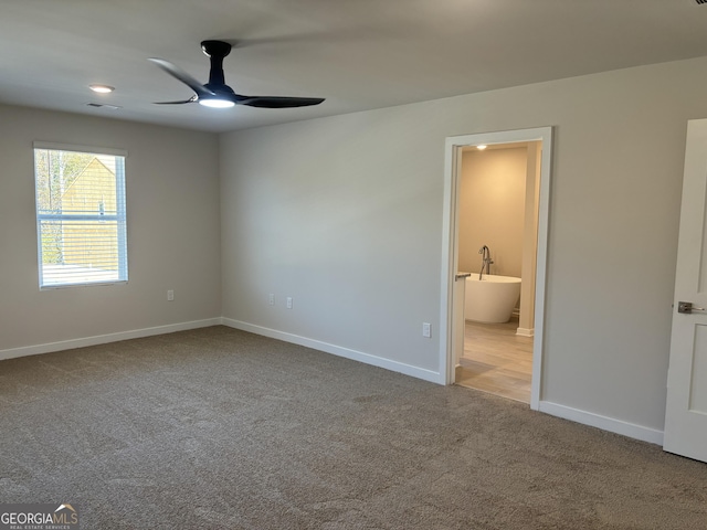 unfurnished bedroom featuring carpet flooring, baseboards, visible vents, and connected bathroom