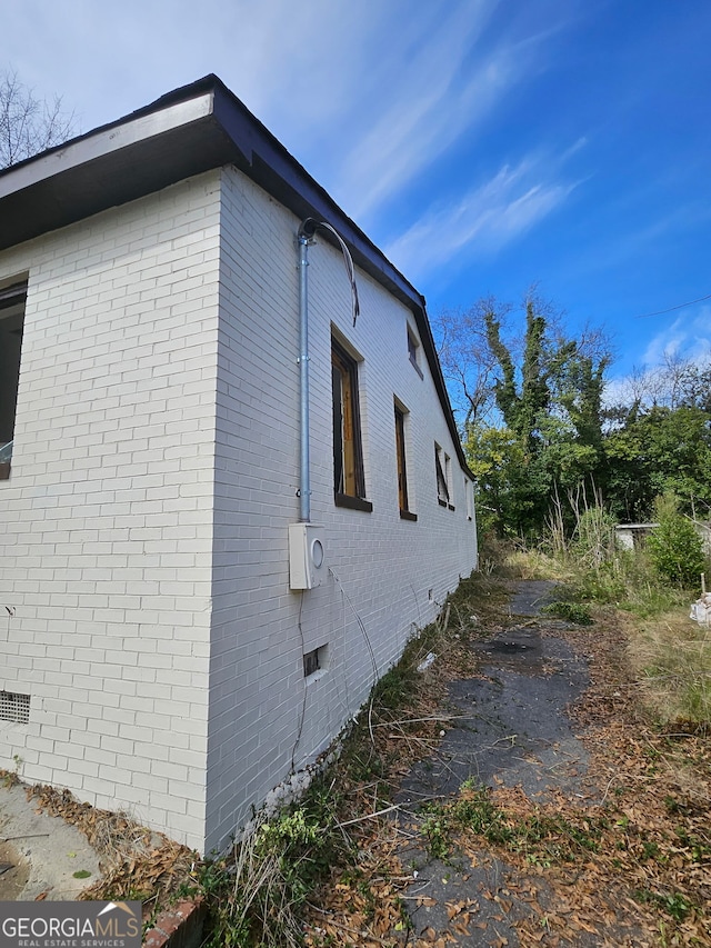 view of side of home with brick siding