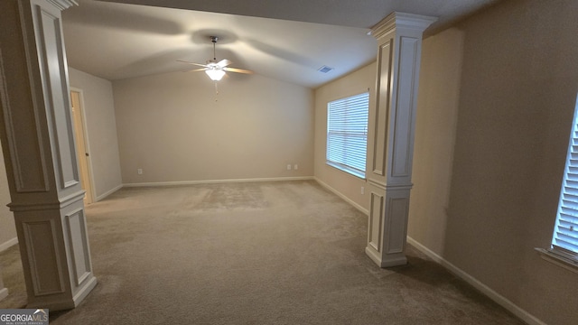 carpeted spare room with baseboards, a ceiling fan, and a wealth of natural light