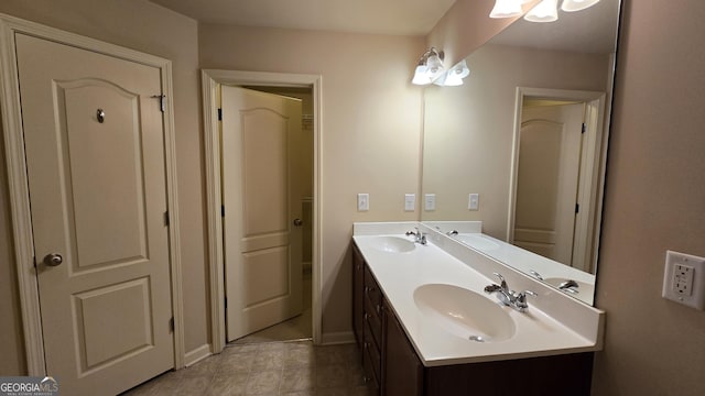 bathroom with a sink, tile patterned floors, and double vanity