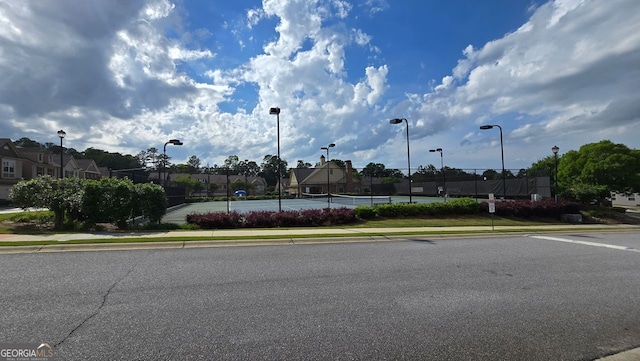 view of street with sidewalks, curbs, and street lights