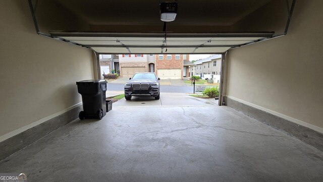 garage featuring baseboards and a garage door opener