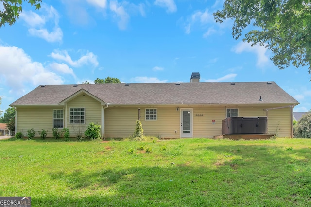 90 Heatherstone Way, Covington, GA 30016 - rear view of property with a lawn, a hot tub, and a chimney