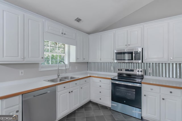 90 Heatherstone Way, Covington, GA 30016 - kitchen with a sink, light countertops, stainless steel appliances, lofted ceiling, and visible vents