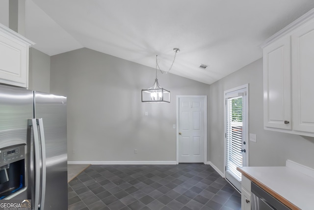 90 Heatherstone Way, Covington, GA 30016 - unfurnished dining area featuring baseboards, a notable chandelier, vaulted ceiling, and dark tile patterned flooring