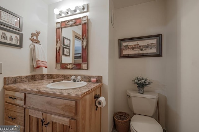 bathroom featuring vanity and toilet
