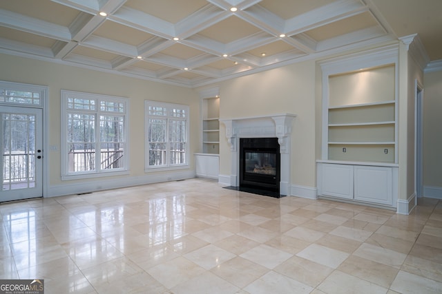 unfurnished living room featuring beam ceiling, built in shelves, a wealth of natural light, and a fireplace