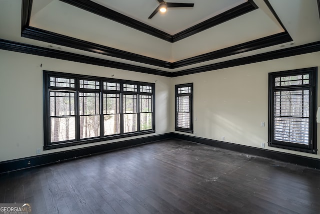 unfurnished room featuring dark wood-style flooring, a ceiling fan, baseboards, and ornamental molding