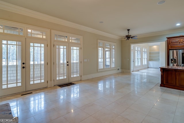 entryway featuring a ceiling fan, french doors, visible vents, baseboards, and ornamental molding