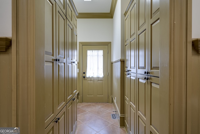 entryway featuring crown molding and light tile patterned flooring