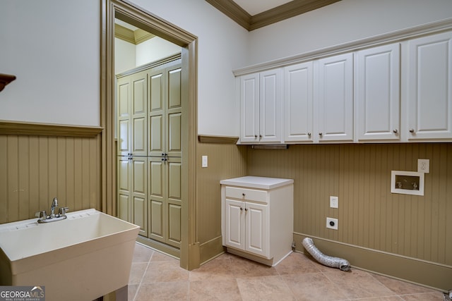 clothes washing area featuring crown molding, cabinet space, washer hookup, wainscoting, and hookup for an electric dryer