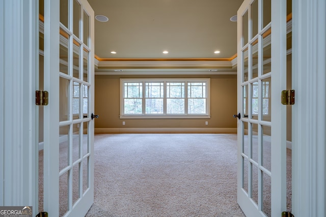 spare room featuring ornamental molding, french doors, and carpet flooring