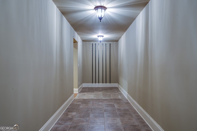 interior space with baseboards and stone finish flooring