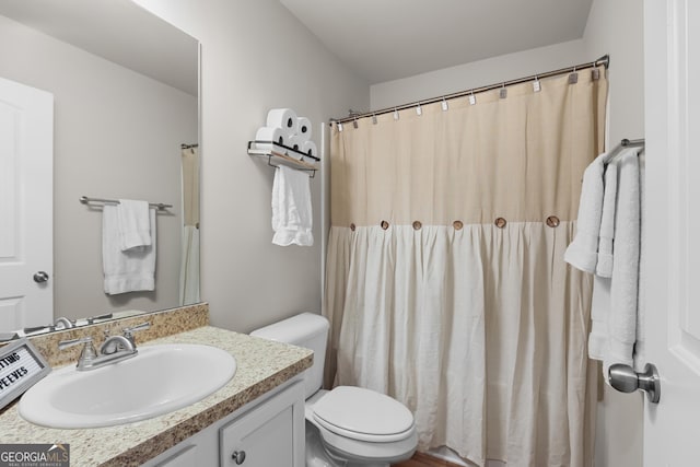 full bath featuring vanity and toilet