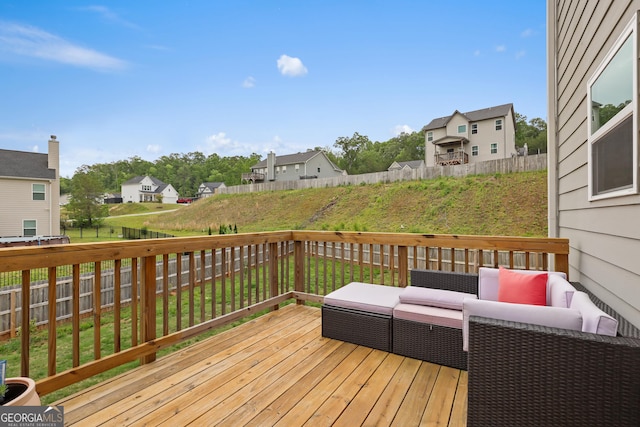 deck featuring a residential view, a yard, an outdoor living space, and a fenced backyard