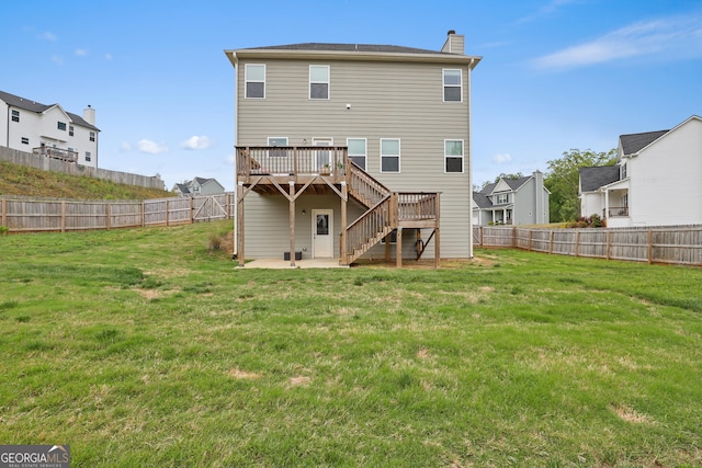 back of house with a fenced backyard, stairs, a chimney, and a deck