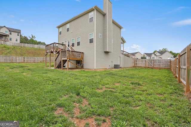 back of property with a deck, a fenced backyard, a chimney, central air condition unit, and stairway