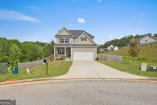 craftsman-style house with a garage, a front lawn, fence, and driveway