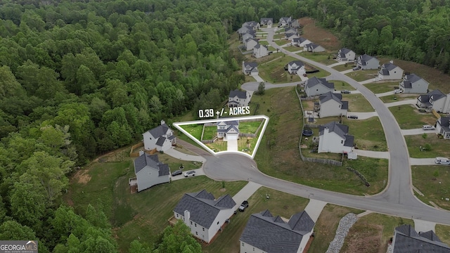 aerial view featuring a residential view and a wooded view