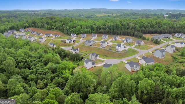 birds eye view of property with a residential view and a wooded view