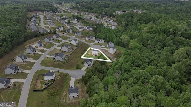 aerial view with a residential view and a wooded view