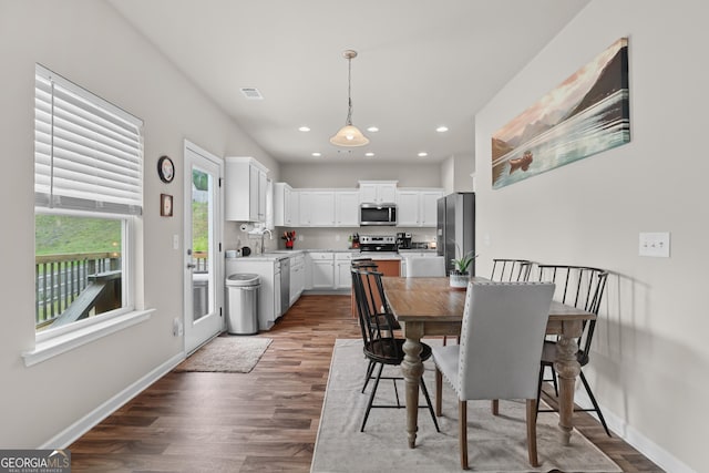 dining room with visible vents, recessed lighting, baseboards, and wood finished floors
