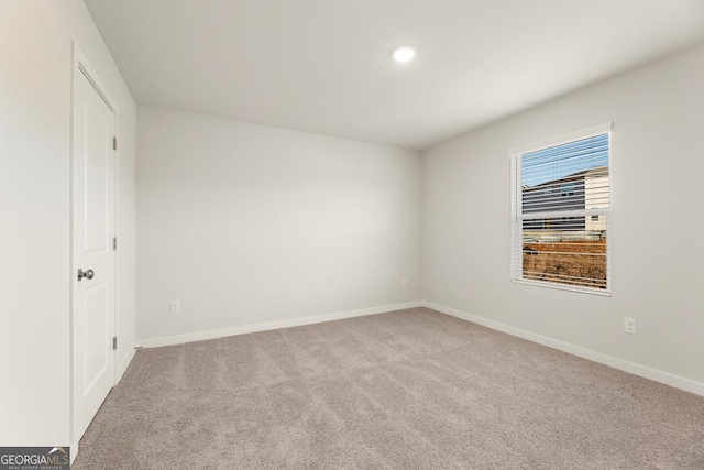 unfurnished bedroom with recessed lighting, baseboards, and carpet