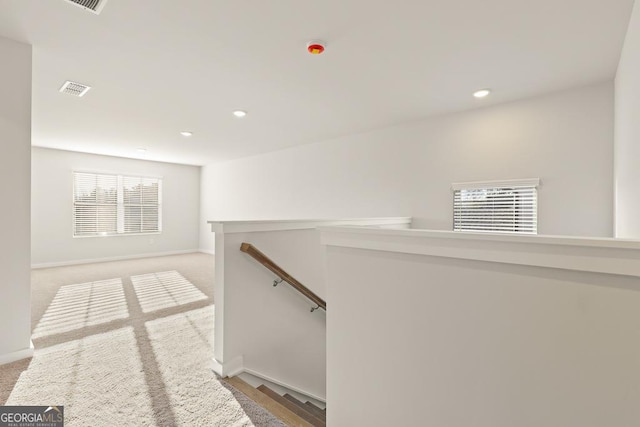 hall featuring recessed lighting, baseboards, an upstairs landing, and visible vents