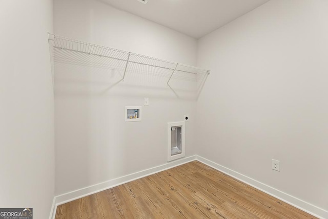 laundry area featuring washer hookup, hookup for an electric dryer, laundry area, baseboards, and light wood-style flooring